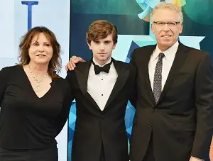 Freddie Highmore with his parents